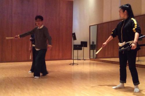 Shigeyama Sennojō III teaches two UHM students, all with a fan in their right hand
